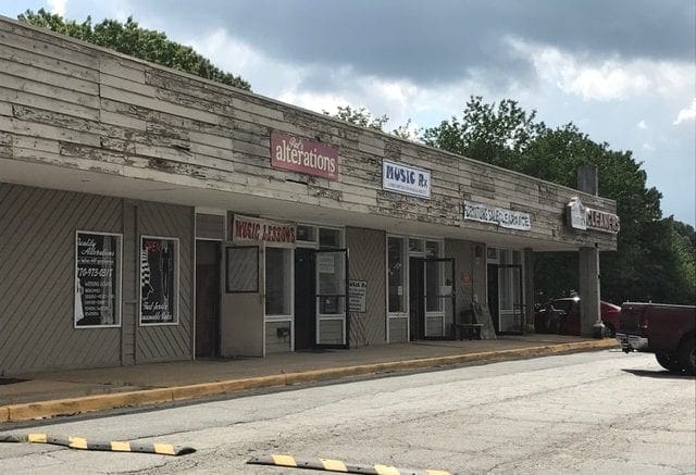 Sprayberry Crossing row of dilapidated storefronts -- there will be a hearing on redevelopment of the property