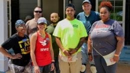 Brian Quinones (center) stands with Georgia National Guard volunteers in front of the Habitat for Humanity home building project that will soon be his home in Austell, Ga., June 16, 2018 -- photo by Capt. Charlies Emmons