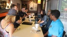 Police officers talk to residents at a Cobb police coffee with a cop