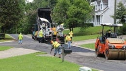Repaving Brookside Drive -- trucks spread asphalt