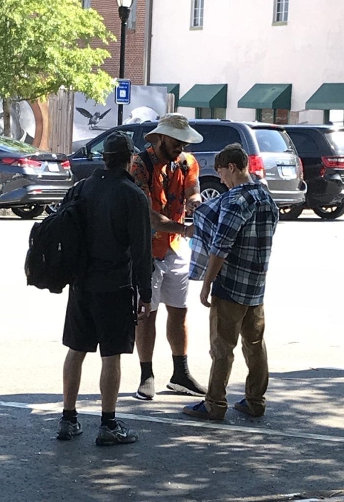 Actor Major Dodson being spritzed for a scene that appeared to involve him running into traffic (photo by Rebecca Gaunt)