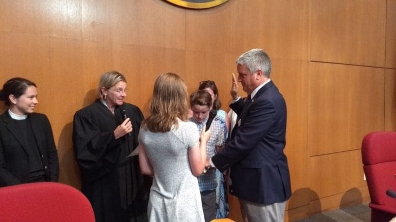 Tim Gould sworn in by Judge Harris flanked by Gould's son and daughter (photo by Haisten Willis)
