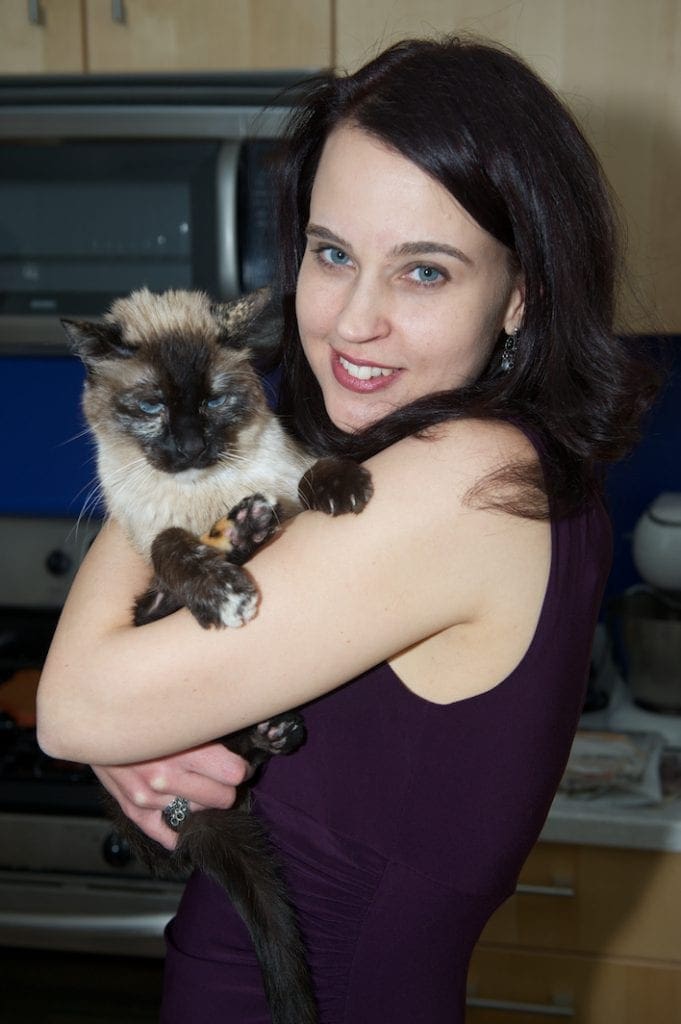 Ingrid with her cat Mamas. She adopted her and her litter of four.