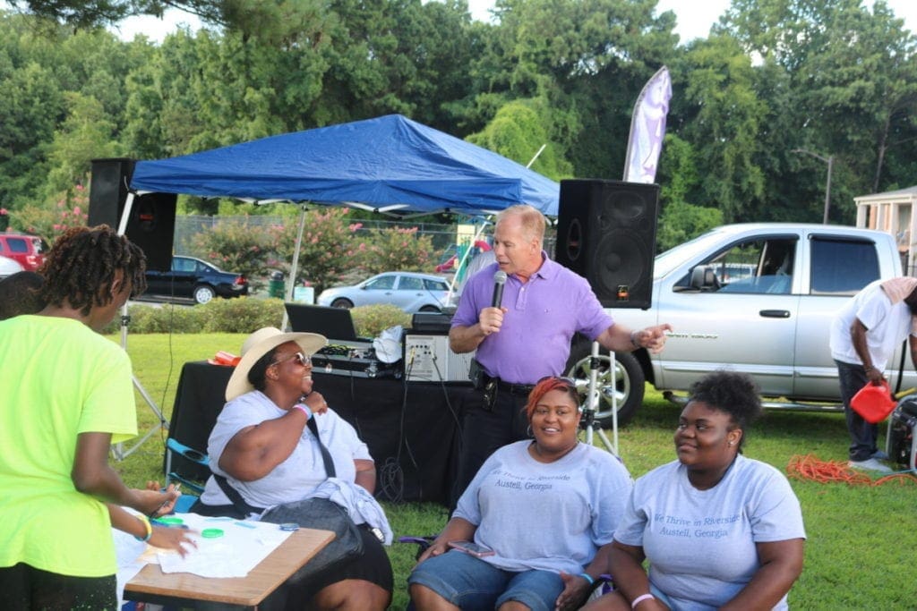 Cobb County Police Chief Michael Register speaks while event organizer Monica Delancy looks on (photo by Larry Felton Johnson)