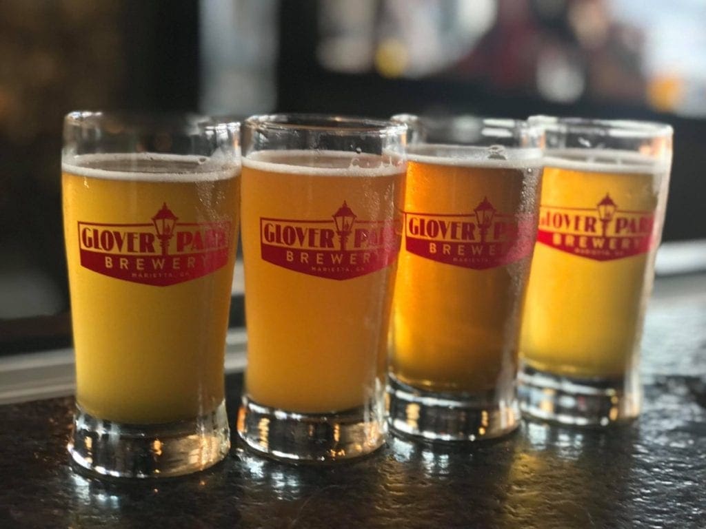 A row of Glover Park Brewery beer glasses filled with gold-colored beer