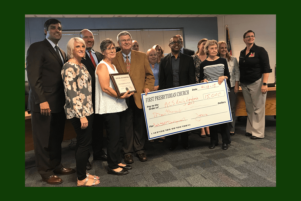 First Presbyterian Church presented a check for $15,000 dollars for the Emily Lembeck Early Learning Center to the board and employee of the month Maren Roedenbeck (far right). (photo by Rebecca Gaunt)