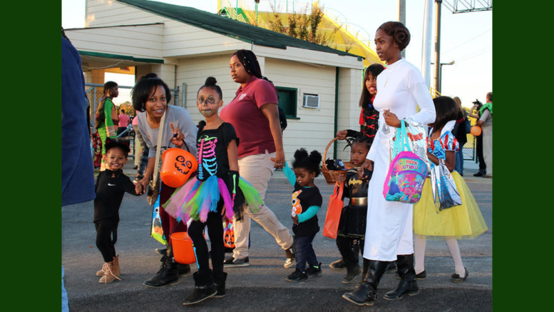 photo of children in costume, with their parents, at a previous Fall Festival of Fun