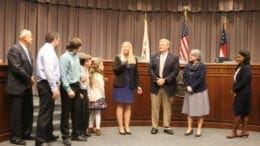 Erica Parish, surrounded by family and commissioners, accepts appointment as Cobb DOT director (photo by Larry Felton Johnson)