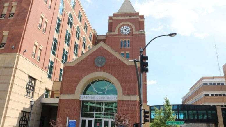 photo of Cobb Superior Court building from the front with a blue sky with clouds in the background