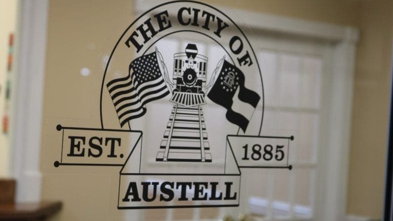 The City of Austell logo on a window in a city office in the Threadmill complex in article about Austell incorporation