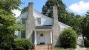 Mable House door with two stone chimneys flanking