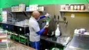 Ron Bolden, owner of Paradise Smoothie Juice Bar, mixes a Green Forest (photo by Larry Felton Johnson)