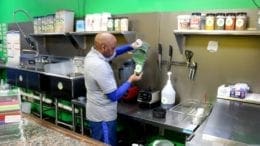 Ron Bolden, owner of Paradise Smoothie Juice Bar, mixes a Green Forest (photo by Larry Felton Johnson)