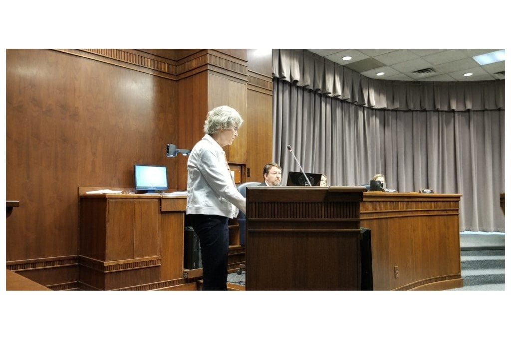 Robin Meyer at lectern at Board of Commissioners meeting.