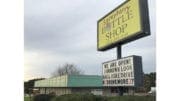 Brij Patel, director of marketing for Sprayberry Bottle Shop, has been vocal with his frustration over the condition of the adjacent Sprayberry Crossing property and the illegal dumping that takes place near his store. He put this sign up in conjunction with the planned social media campaign. (photo by Rebecca Gaunt)