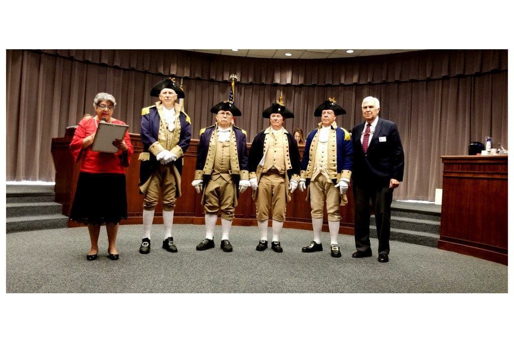Commissioner JoAnn Birrell presents Patriots Day proclamation to Sons of the American Revolution members. (photo by Larry Felton Johnson)