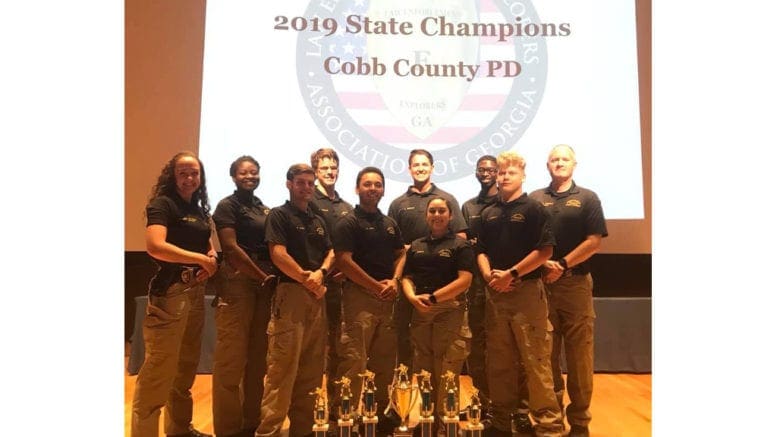 Cobb Police Explorers display trophies from their 11th consecutive state championship