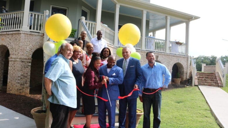 Ducere CEO Markesia Akinbami, and Chairman Korey Akinbami. flanked by Austell Mayor Pro Tem Valerie Anderson and Mayor Ollie Clemons, cut the ribbon for the opening of the headquarters of Ducere