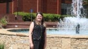 Sarah Shurden in front of the fountain at Austell's Threadmill complex