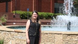 Sarah Shurden in front of the fountain at Austell's Threadmill complex