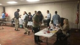Plant McDonough employees serving chili at a benefit for an LGBTQ youth homelessness project