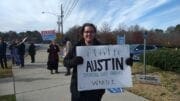 Austin Wagner holding sign on Spring Road
