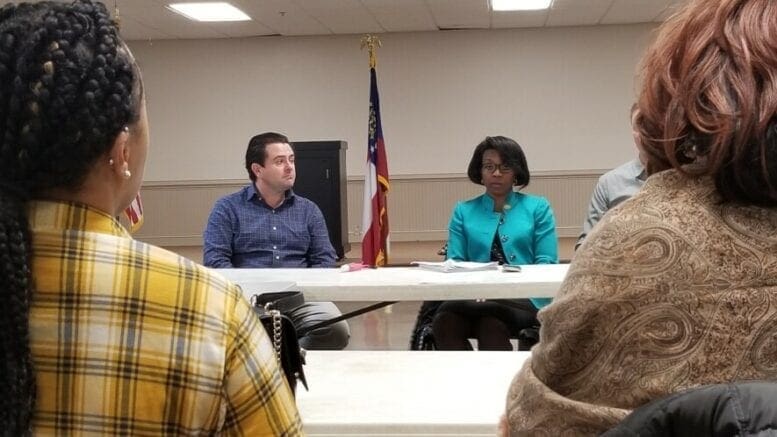 Neighbors seated at a table talking to Ryan Teague of Baldwin Paving