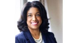 Jannquell Peters headshot smiling wearing a blue jacket