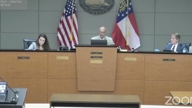 L-r City clerk Lea Addington, Mayor Derek Easterling and City Attorney Randall Bentley conduct the meeting from City Hall, as council members join them via Zoom.