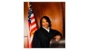 Judge Kellie Hill standing beside the bench
