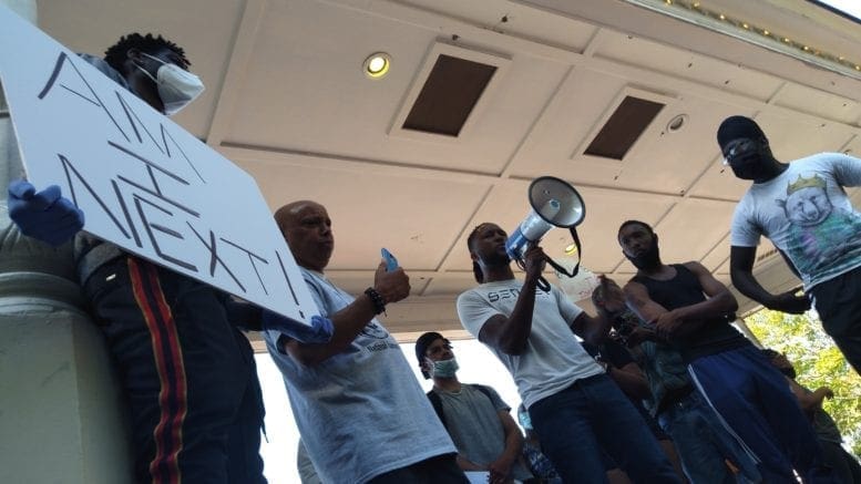 Speaker with bullhorn at Black Lives Matter demonstration in Marietta