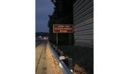 Photo of sign reading "Lester and Virginia Maddox Bridge"