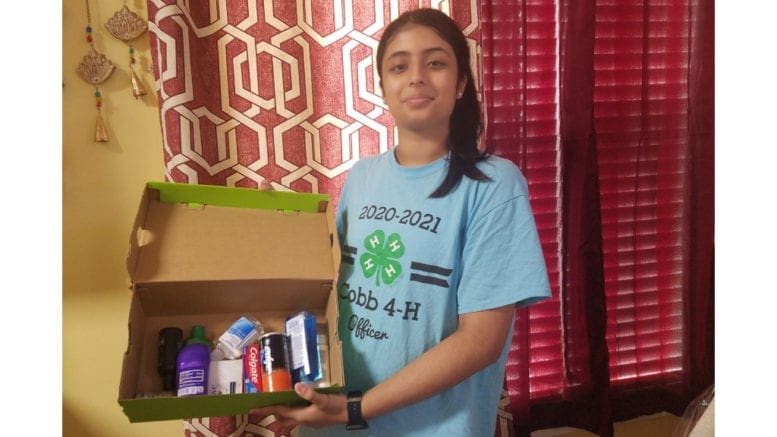 4-H member displaying her gift to mothers in substance abuse recovery (photo courtesy of CCCSB)