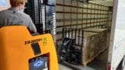 Forklift unloading pallets of Chromebooks for Cobb schools