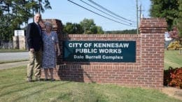 Mayor Derek Easterling and Judi Burrell in front of newly named Dale Burell Complex