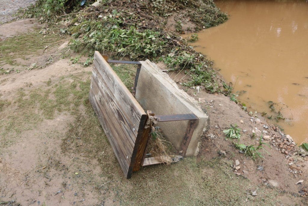 Bench and concrete base knocked over by the flooding
