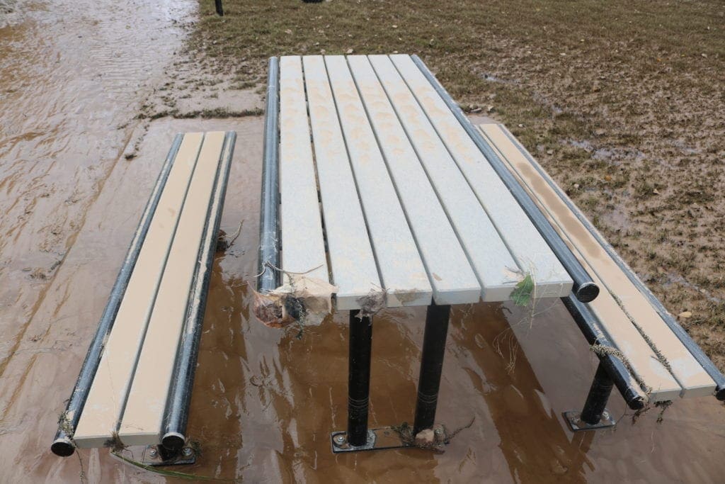 Mud and water around benches on the west side of the path (photo by Larry Felton Johnson)
