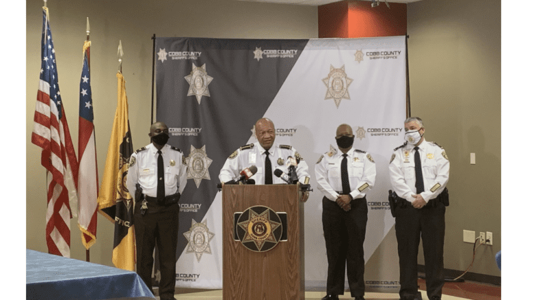 Sheriff Craig Owens and part of his command staff announce major reforms to the Cobb sheriff’s office. Pictured from left to right: Col. Temetris Atkins, Sheriff Craig Owens, Chief Deputy Rhonda Anderson and Maj. Steven Gaynor all wearing dress white shirts surrounding lectern