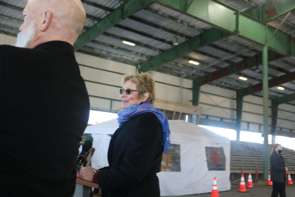 Dr. Kathleen Toomey in at microphones during a press conference