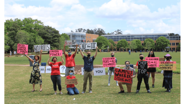 Union members hold up signs at KSU