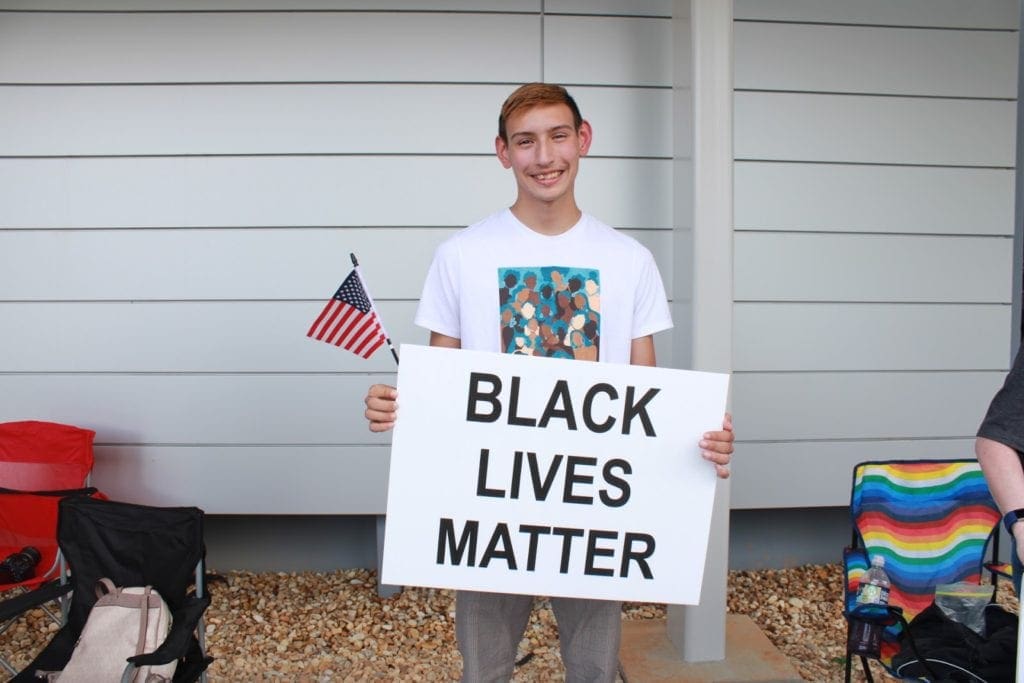 Young man with Black Lives Matter sign