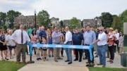 People lined up behind ribbon for ribboncutting ceremony