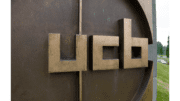 metal logo on signage outside a UCB building