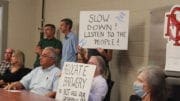 Smyrna residents, some holding signs opposing Smyrna redevelopment plan