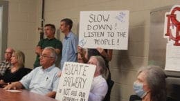 Smyrna residents, some holding signs opposing Smyrna redevelopment plan