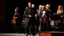 Music Director and Conductor Timothy Verville (pictured, standing center) leads the Georgia Symphony Orchestra’s return to live performances in its upcoming 71st concert season