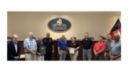 line of people some holding certificates from GACP