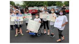 People with pro-mask-mandate signs