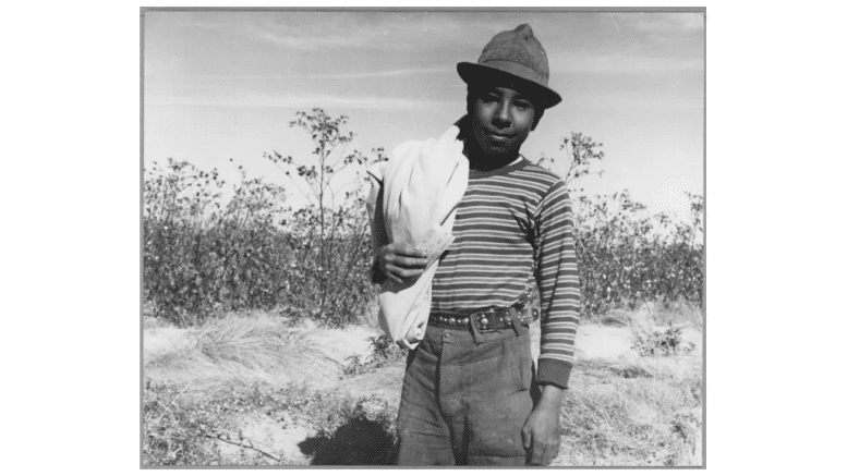 Young Hispanic male with bag thrown over shoulder