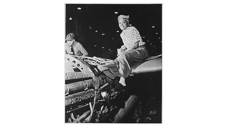 Woman smilling on partially assembled aircraft